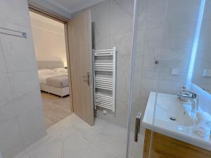 a bathroom with a shower and a sink and a toilet at Atsiki's 89 Apartments in Chios +107 photos