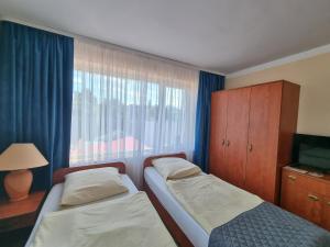 Posteľ alebo postele v izbe v ubytovaní Gościniec pod Polną Różą 2