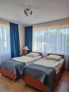 Posteľ alebo postele v izbe v ubytovaní Gościniec pod Polną Różą 2