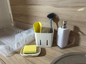 a cup with a toothbrush and a toothbrush holder at Apartment Liriq - Free Parking in Sarajevo +41 photos