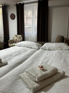 a white bed with towels on it with a window at Apartment Liriq - Free Parking in Sarajevo