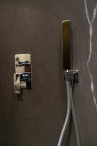 a close up of a toothbrush holder on a wall at VS LUXURY SUITE with SPA in Bari +18 photos