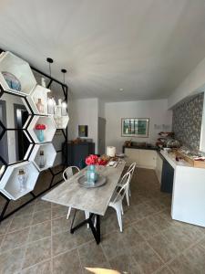 a dining room and kitchen with a table and chairs at Aliston Hotel Thassos in Skala Potamias