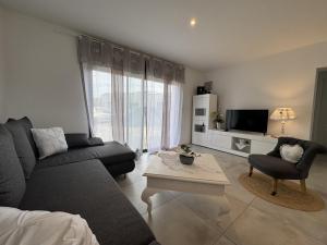 RuaudinにあるLe Refuge - Confort - 5 pers - Rêve au Mansのソファとテーブルのあるリビングルーム