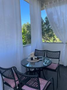 a table and chairs in a room with a window at Apartmani Marković RAB in Palit