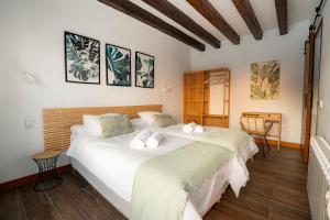 a bedroom with a large white bed in a room at The Cube in Zahara de los Atunes