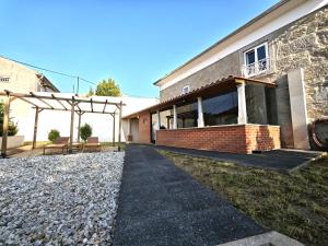 a brick house with a patio and a stone walkway at Well at Home in Vila Nova de Gaia