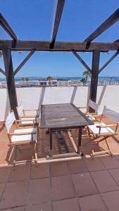 a picnic table and chairs on top of a roof at Casa Tuca by 7Escalones in Rota