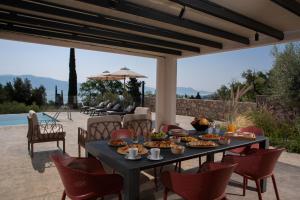 a table with food on it on a patio at Bitter Almond Trees in Nikiana