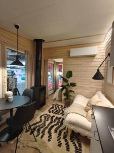 a living room with a couch and a table at Kotatieva Resort in Rovaniemi