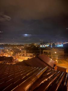 a view of a city at night with lights at Departamento en Misicata in Cuenca +4 photos