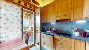 a kitchen with wooden cabinets and a counter top at Abitaziun Süls Ers 11 - Pontresina in Pontresina