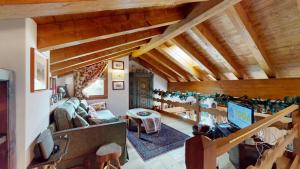 a living room with wooden ceilings and a staircase at Abitaziun Süls Ers 11 - Pontresina in Pontresina
