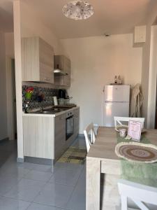 a kitchen with a table and a stove and a refrigerator at Casa Numana Adamo ed Eva resort in Numana