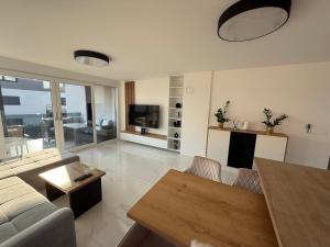 a living room with a couch and a table at Apartmen ARMINAN 52 TERRACE, POOL FREE PARKING -NOVIGRAD in Novigrad Istria