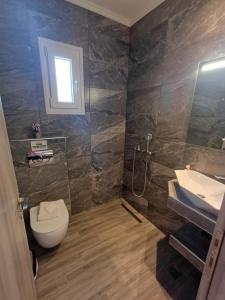 a bathroom with a toilet and a sink at Summer Paradise in Paralia Sikias +40 photos