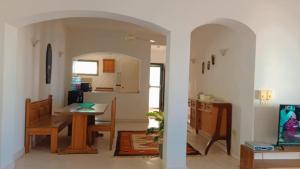 a kitchen and dining room with a table and a dining room at Romantic Chalete قرية الغرندل in Ras Sedr