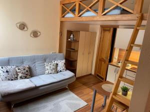 a living room with a couch and a bunk bed at Pas Jūrate Villa Hubertus in Juodkrantė