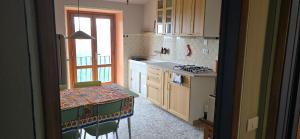 a kitchen with a table and a stove top oven at La Casa del Tramonto in Vellano