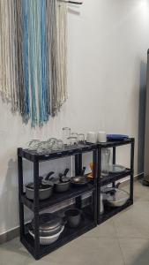 a shelf filled with pots and pans on a wall at Apartamento Sol da Manhã in Morro de São Paulo