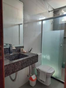a bathroom with a sink and a toilet and a shower at Apartamento Sol da Manhã in Morro de São Paulo