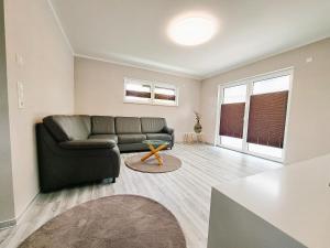 a living room with a couch and a table at Ferienhaus "Laila" ID 16019-2 in Möllenhagen