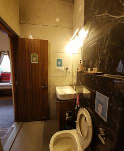 a bathroom with a toilet and a sink at LiveAway Mukteshwar, Nainital by PACK in Mukteswar