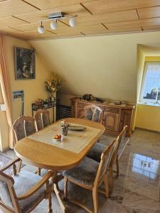 a dining room with a wooden table and chairs at Lehnert in Grube