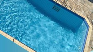 an overhead view of a pool of blue water at Aliston Hotel Thassos in Skala Potamias