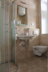 a bathroom with a shower and a sink and a toilet at Apartment Iva in Split