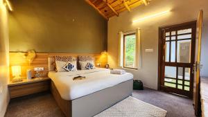 a bedroom with a large bed and a window at LiveAway Mukteshwar, Nainital by PACK in Mukteswar