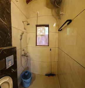 a bathroom with a shower and a window and a sink at LiveAway Mukteshwar, Nainital by PACK in Mukteswar +12 photos