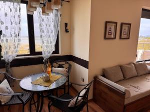 a living room with a table and a couch at Sea View Escape in Burgas +12 photos