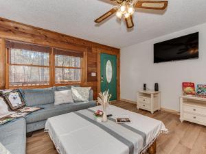 a living room with a couch and a ceiling fan at Lake Norman Retreat with Hot Tub, Kayaks & Paddleboards in Mooresville