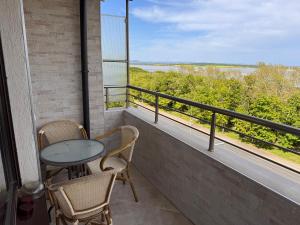a balcony with a table and chairs and a view of the water at Sea View Escape in Burgas