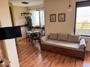 a living room with a couch and a table at Sea View Escape in Burgas