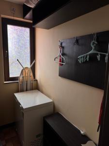 a laundry room with a toilet and a window at Sea View Escape in Burgas