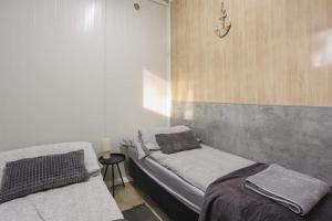 a bedroom with two beds and a side table at Domki Bliżej Gwiazd in Krasnobród