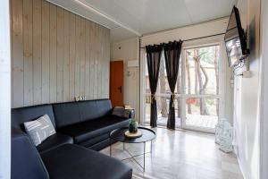 a living room with a couch and a table at Domki Bliżej Gwiazd in Krasnobród