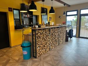 a bar with a pile of fire wood at Camping Amazing Village in Klisurski Manastir