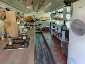 a kitchen with a stove in the middle of a room at La Busuri Camp in Roşia