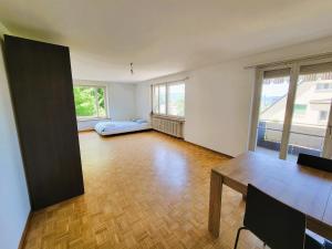 ein leeres Wohnzimmer mit einem Tisch und einer Couch in der Unterkunft City Center Flats with Balcony & Garden View Rigi - Self Checkin in Zürich + 45 Fotos