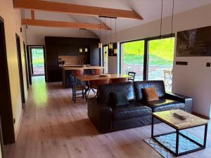 a living room with a couch and a table at Glamping Máchův kraj in Doksy