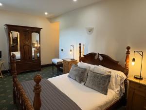 a bedroom with a large bed with two pillows at Craig-Y-Nos Castle in Abercraf +64 photos
