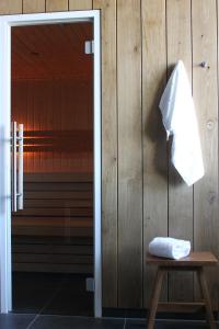 a towel hanging on a wall next to a door at Boutique Hotel Texel in De Cocksdorp +115 photos