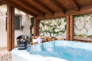 a jacuzzi tub on a patio at Къщи за гости Сноуфлейк Snowflake Chalet and Snowflake Lodge in Bansko