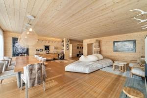 a bedroom with a bed and a wooden ceiling at Chesa Wolf Zuoz in Zuoz