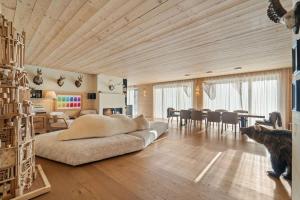 a living room with a large couch and a dining room at Chesa Wolf Zuoz in Zuoz +45 photos
