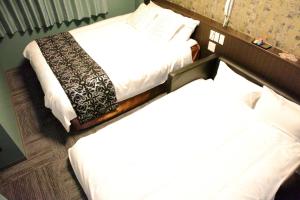 Postel nebo postele na pokoji v ubytování HOTEL neoWorld