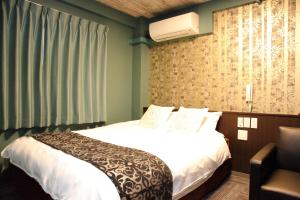 Postel nebo postele na pokoji v ubytování HOTEL neoWorld